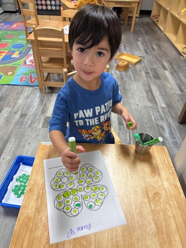 Toddler exploring Montessori learning materials at Amici Trilingual Montessori near Gilbert AZ